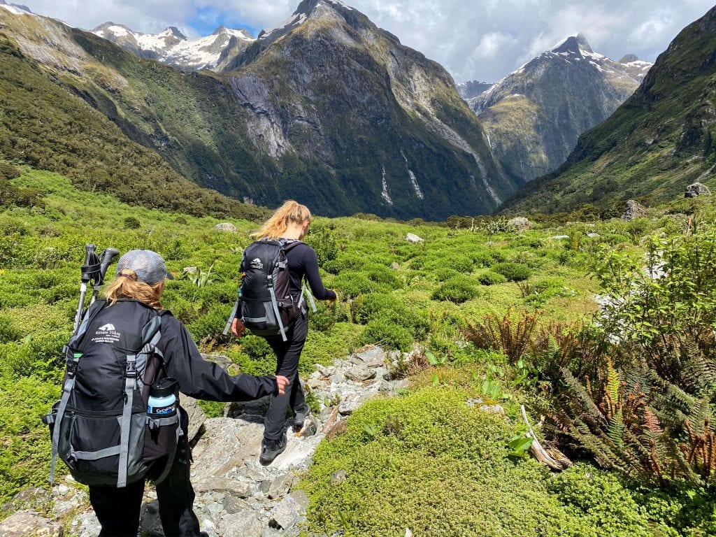 two girls hiking the milford track in the southland region 